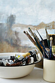 Brushes and paints in studio of artist