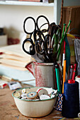 Scissors and treads on workbench in studio of textile artist Exeter, Devon