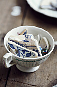Broken tile fragments in teacup in studio of still life painter