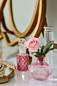 Pink single stem rose on dressing table in Devon home, UK