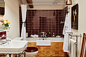 Maroon tiled bathroom with shower rail Lot et Garonne, France