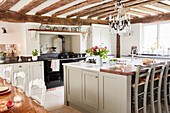 Antique French chandelier in renovated Grade II listed timber framed farmhouse kitchen Kent, UK