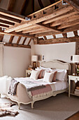 French antique bed and lamps in beamed Grade II listed farmhouse Kent, UK
