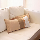 White leather sofa with geometrically patterned gros and silk neutral cushions