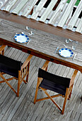 Elevated view of shaded director's chairs and place settings