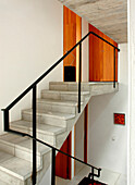 The open staircase from the ground floor to the bedrooms are built of small concrete squares with a steel handrail