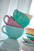 Pastel coloured teacups in a stack