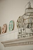 Salvaged birdcage and decorative plates