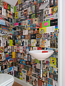 Under stairs bathroom walls lined with assorted postcards