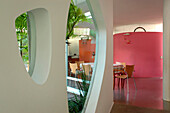 Smoothed concrete floor to dining room decorated in pink a colour which stimulate appetite