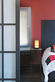 Opaque glass doorframe to bedroom with bedside lantern