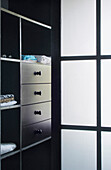 Dressing room area with open shelving and drawers