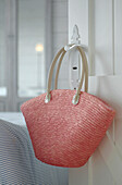 Pastel pink shopping bag on door handle