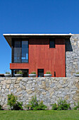 Beach house exterior with stone wall