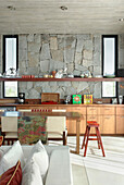 Open plan kitchen with exposed stone wall