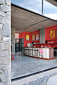 Red kitchen are with seating and concrete floor