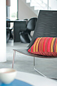 Black chair in beach house with red striped cushion