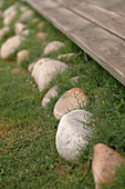 Stone pebbles bordering beach house lawn