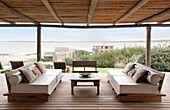 Sofas with bolsters on beach house deck