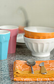 Brightly coloured tableware on marble tabletop