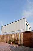 Building exterior with galvanized metal sheeting and rusted metal garage
