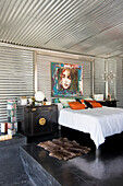 Galvanized metal bedroom with Chinese furniture and modern artwork