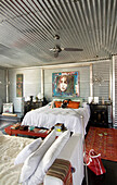 Galvanized metal bedroom with Chinese furniture and rabbit-fur covered chaise longue