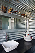 Bathroom with galvanized sheets a rectangular mirror and shower screen