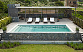 Sunloungers on poolside decking