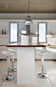 All white kitchen with barstools at raised counter