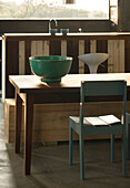 Sunlight falls on dining table with large green ceramic bowl