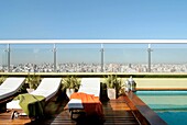 Sun loungers next to swimming pool on roof garden, Buenos Aires, Argentina