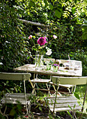 Painted table and chairs in English country garden