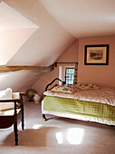 Attic bedroom in country house with dormer windows