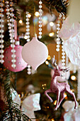 Pink baubles and reindeer decoration on Christmas tree
