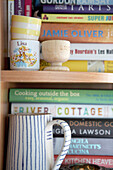Eggcups and striped milkjug on bookcase