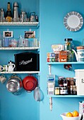 Kitchenware on open shelving of 1950s style kitchen