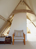 Chair and suitcase in pitched attic conversion