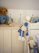 Soft toys in panelled child's bedroom