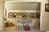 Circular table and chairs with under eaves storage in farmhouse conversion