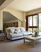 Cream sofa and coffee table at patio doors of farmhouse conversion
