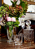 Glass decanters and cut flower in Grade I listed Elizabethan manor house in Kent 