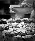 Icing almond pastries in a bakery