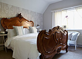Carved wooden bed in Edwardian school house conversion