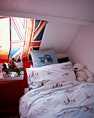 Union Jack flag in attic window of bedroom in Edwardian school house conversion