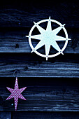 Star shaped Christmas decorations on wooden building exterior