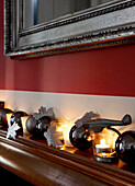 Christmas decorations and lit candles on mantelpiece in Grade II listed Georgian townhouse in London