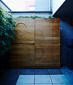 Wood panel with bamboo in blue interior courtyard