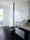 White tiled bathroom with glass shower screen