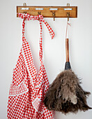 Red and white checked apron and feather duster in 18th Century Georgian kitchen Hampstead, London